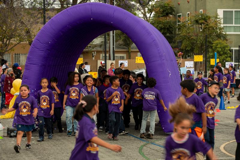 Students running through the bubble arch