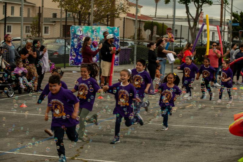 Students running toward the bubble tunnel