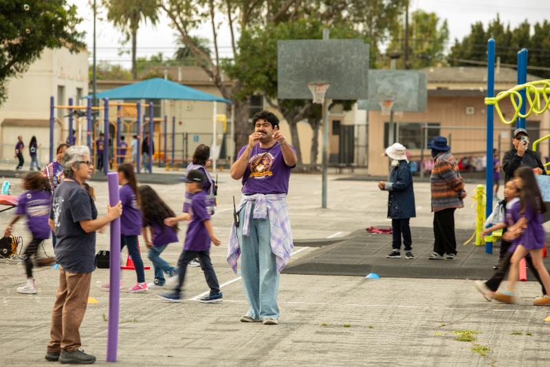 Students running through the bubble arch on the yard