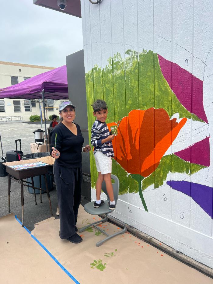 Students painting mural flowers