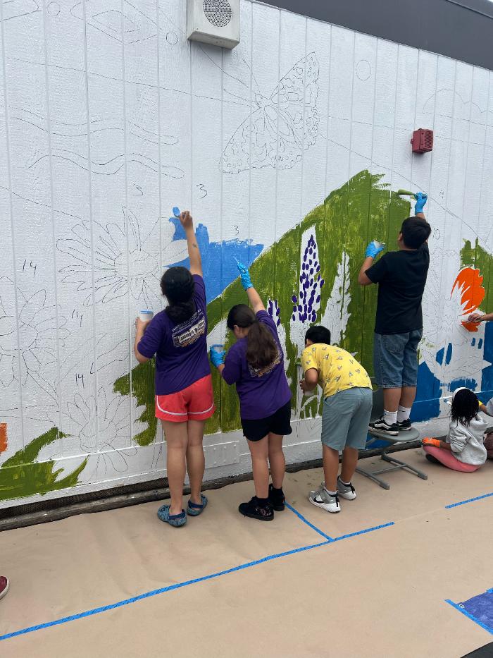 Parent and child painting a poppy