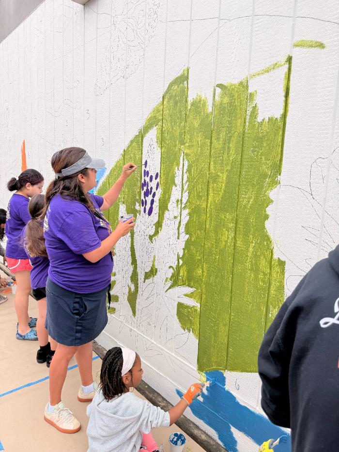 Families gathered at the mural wall