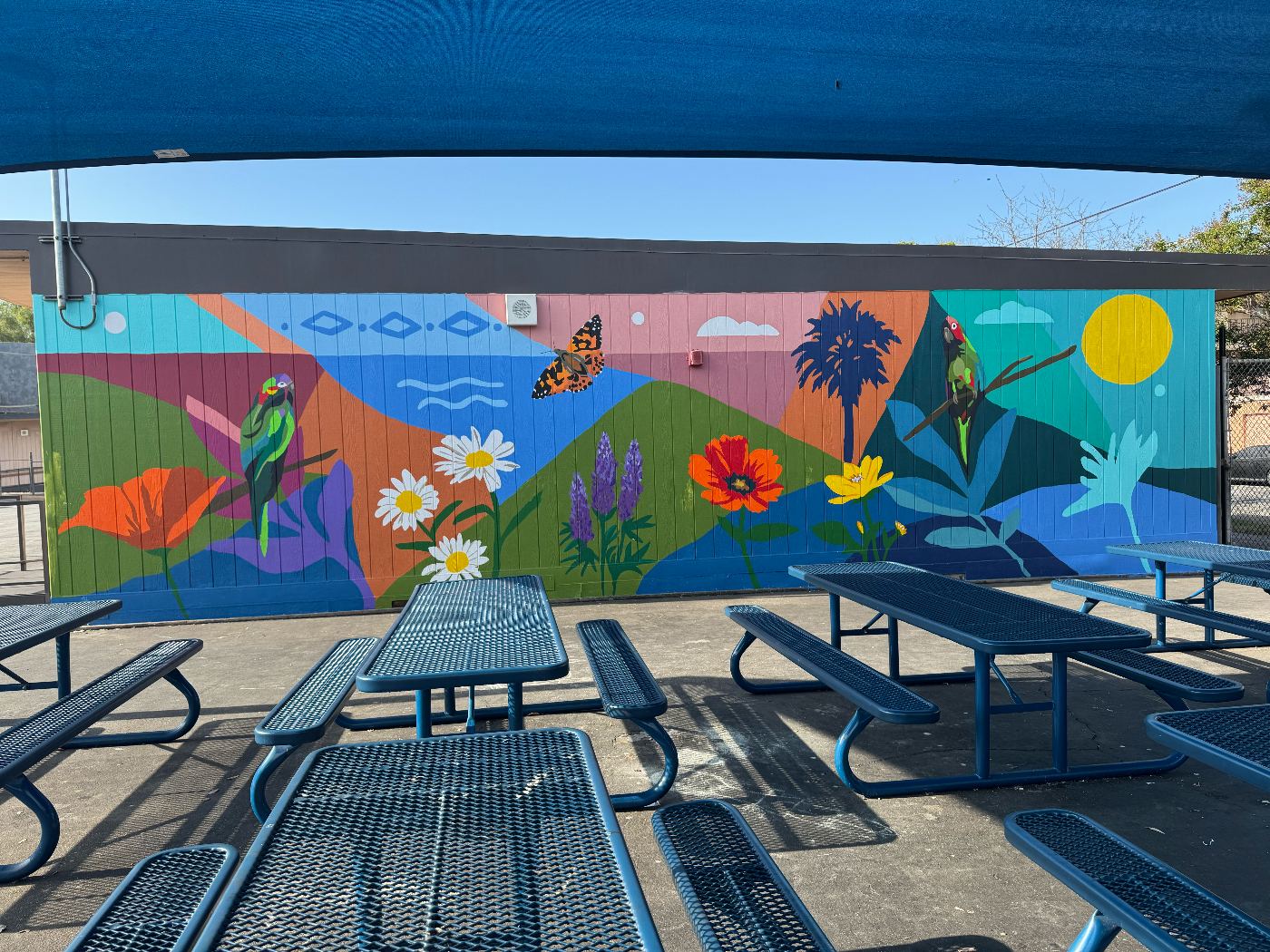 Finished mural with birds, flowers, and California coastline